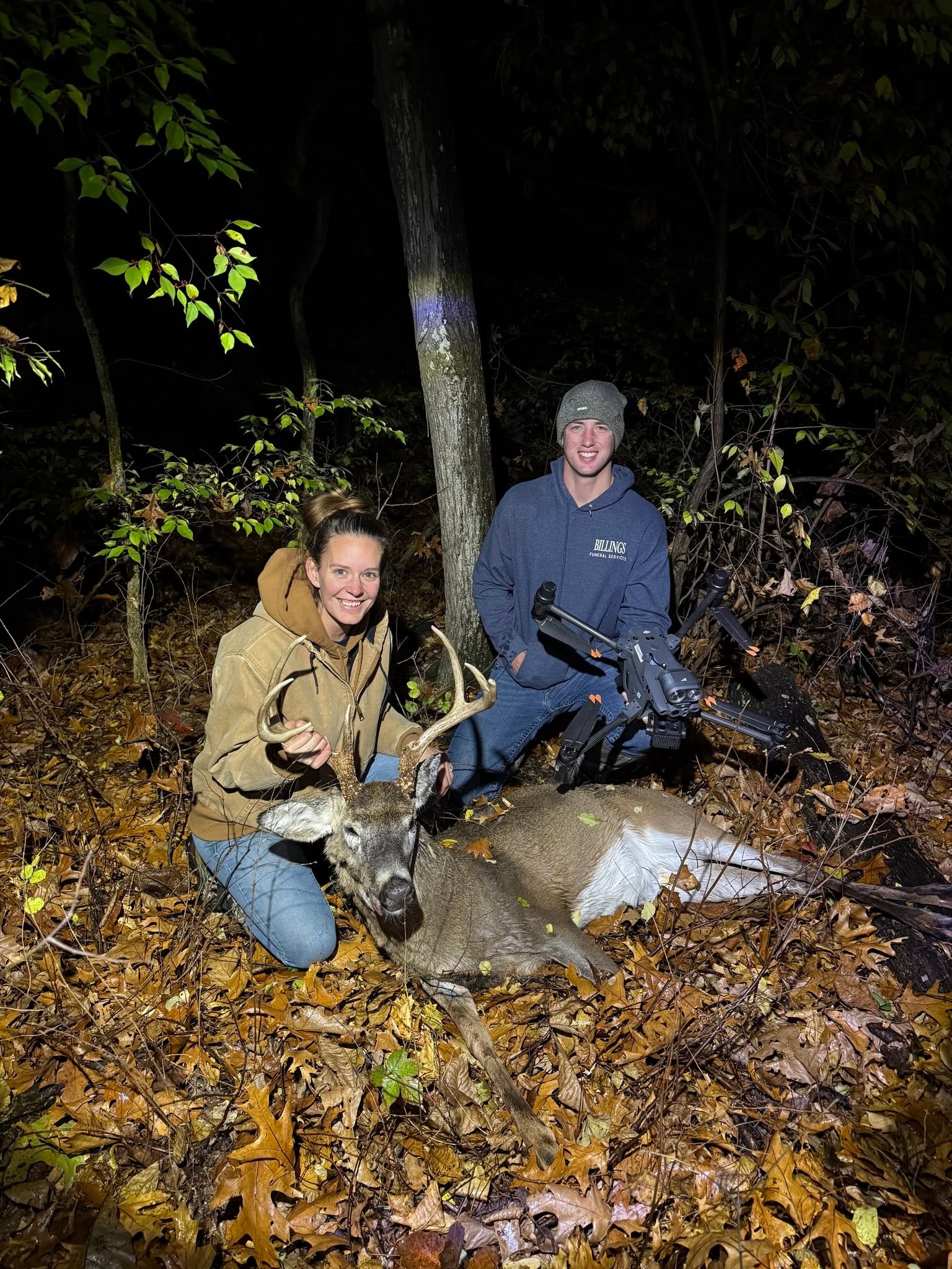 Recon1 pilot and hunters with a recovered buck at night