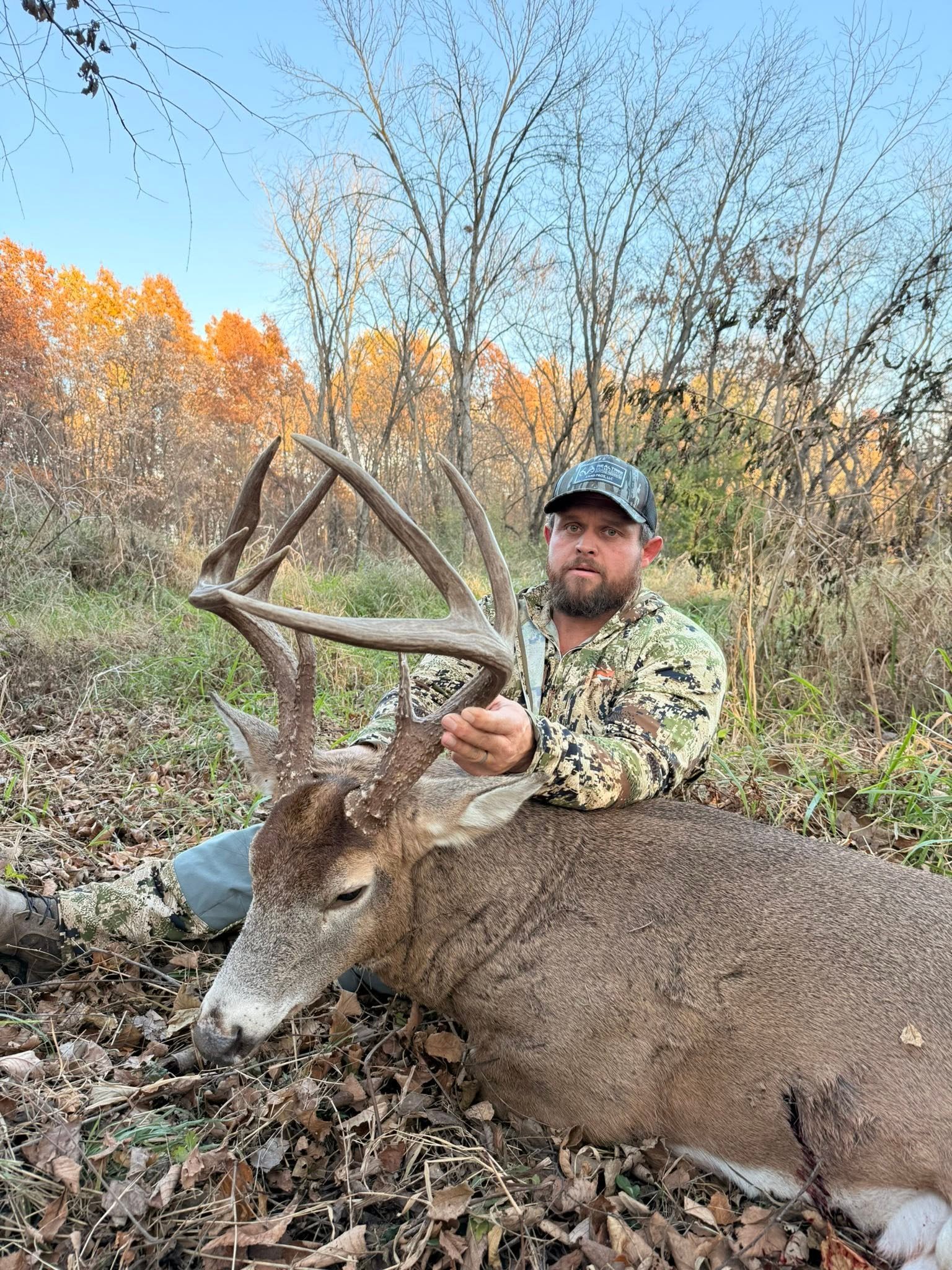 Bowhunter with a recovered whitetail buck, Recon1 branded photo